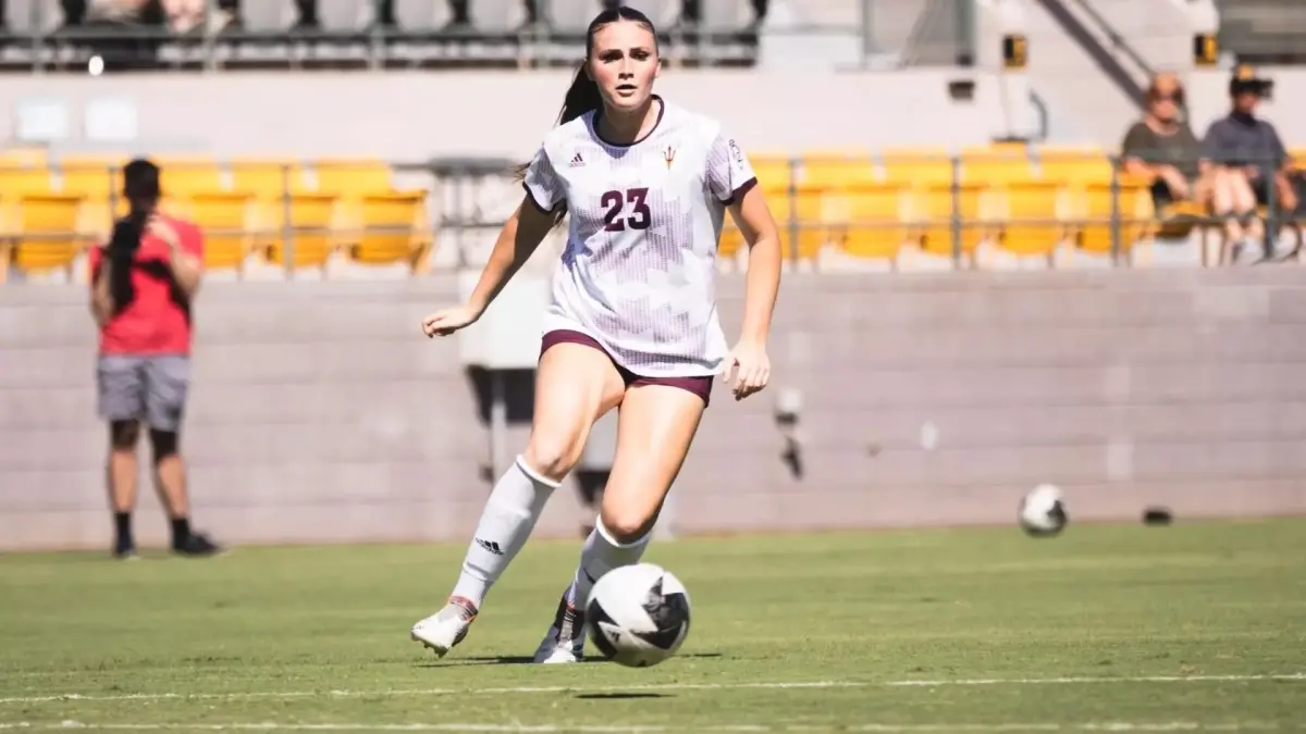woman running down field with soccer ball woman running down field with soccer ball
