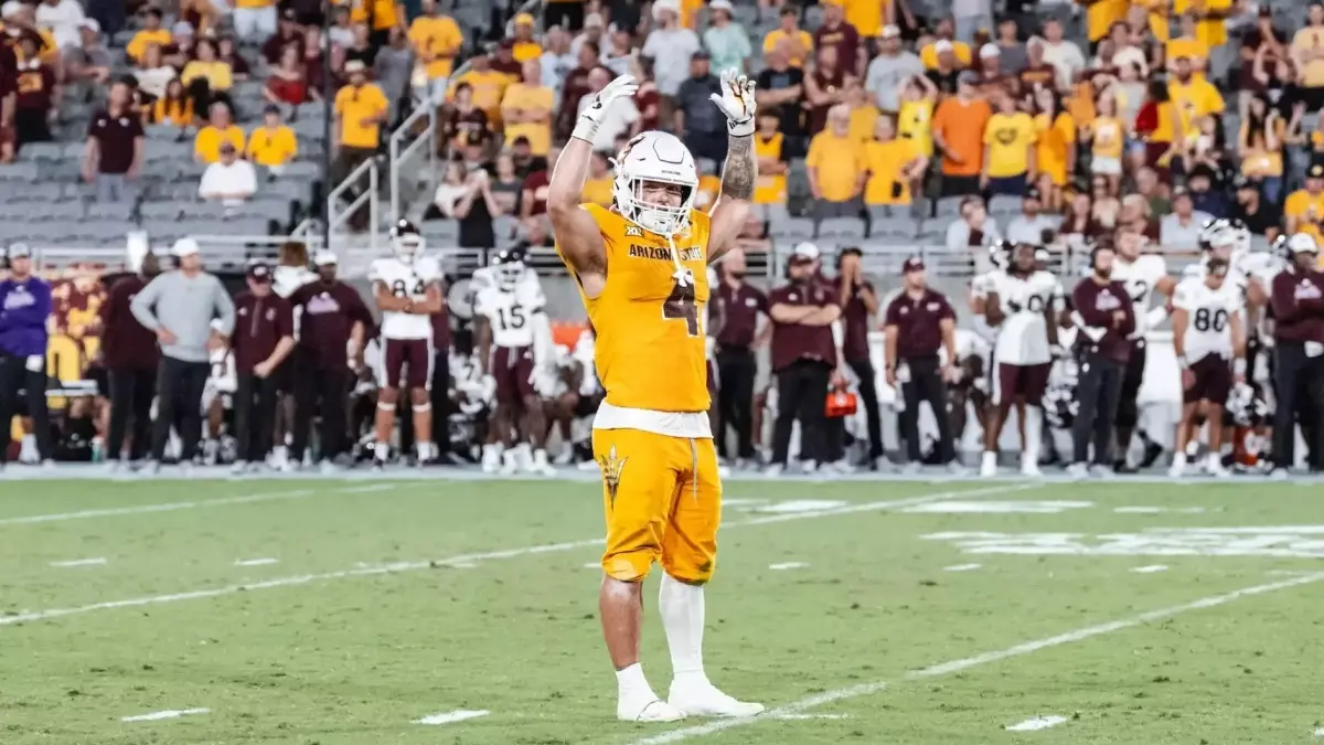 football player in gold uniform on field football player in gold uniform on field