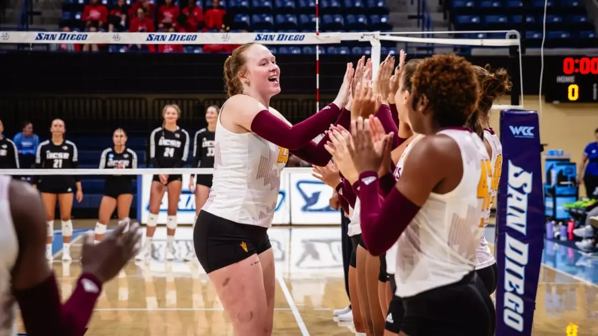 volleyball player high fiving on court 