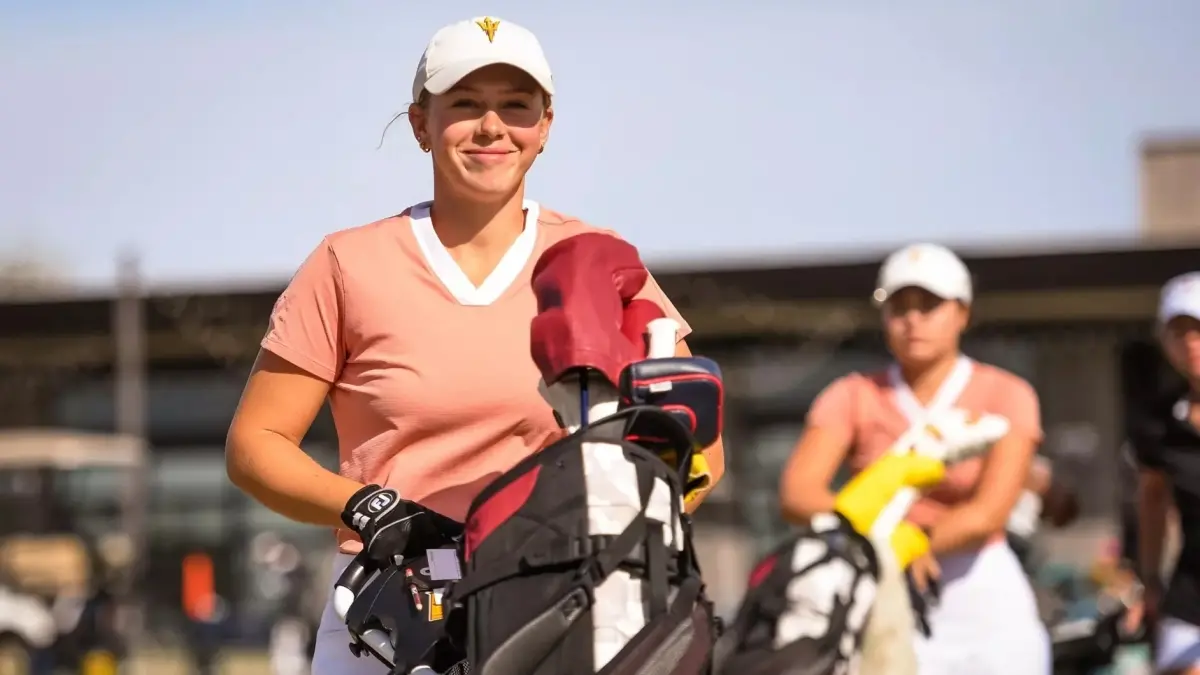 woman carrying golf caddy woman carrying golf caddy