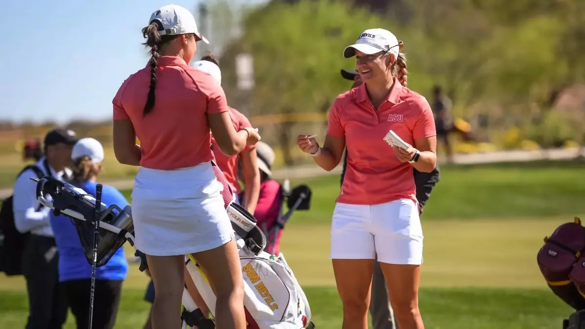 two womens golf players talking