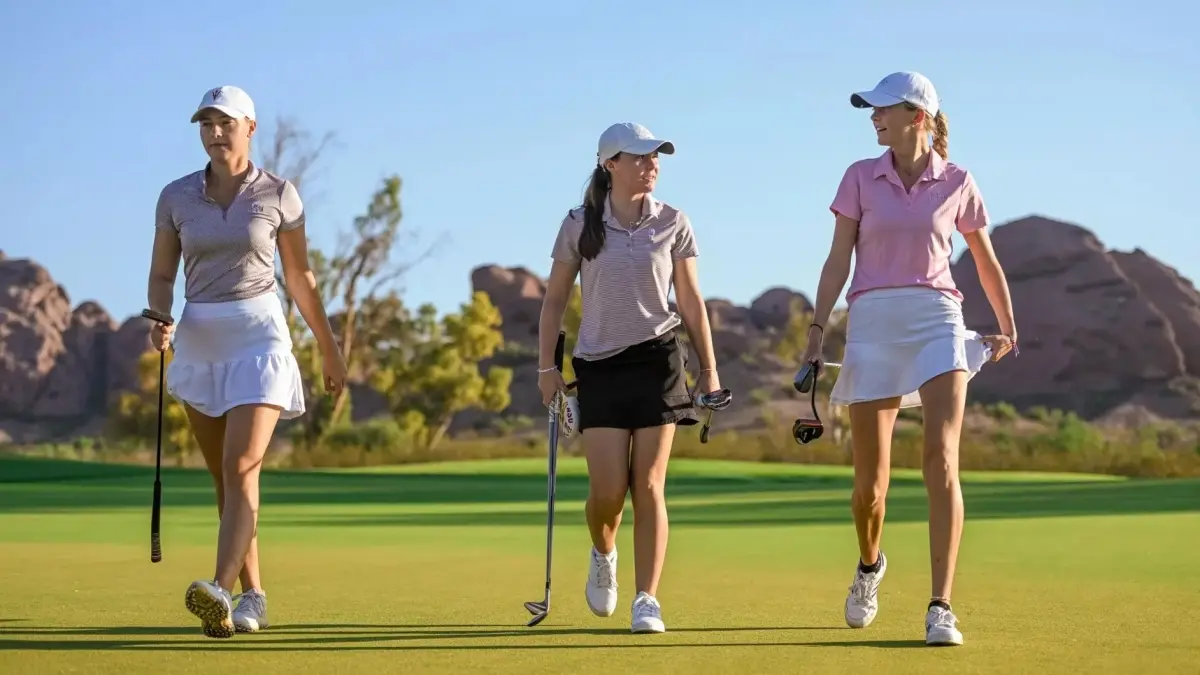 three golf players walking three golf players walking