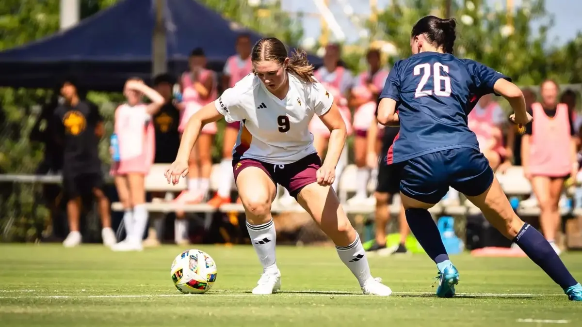 soccer player running down field with ball