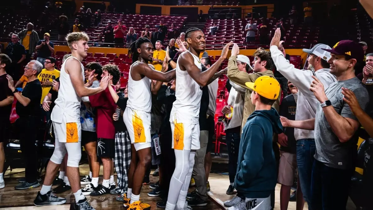 males basketball team high-fiving crowd males basketball team high-fiving crowd