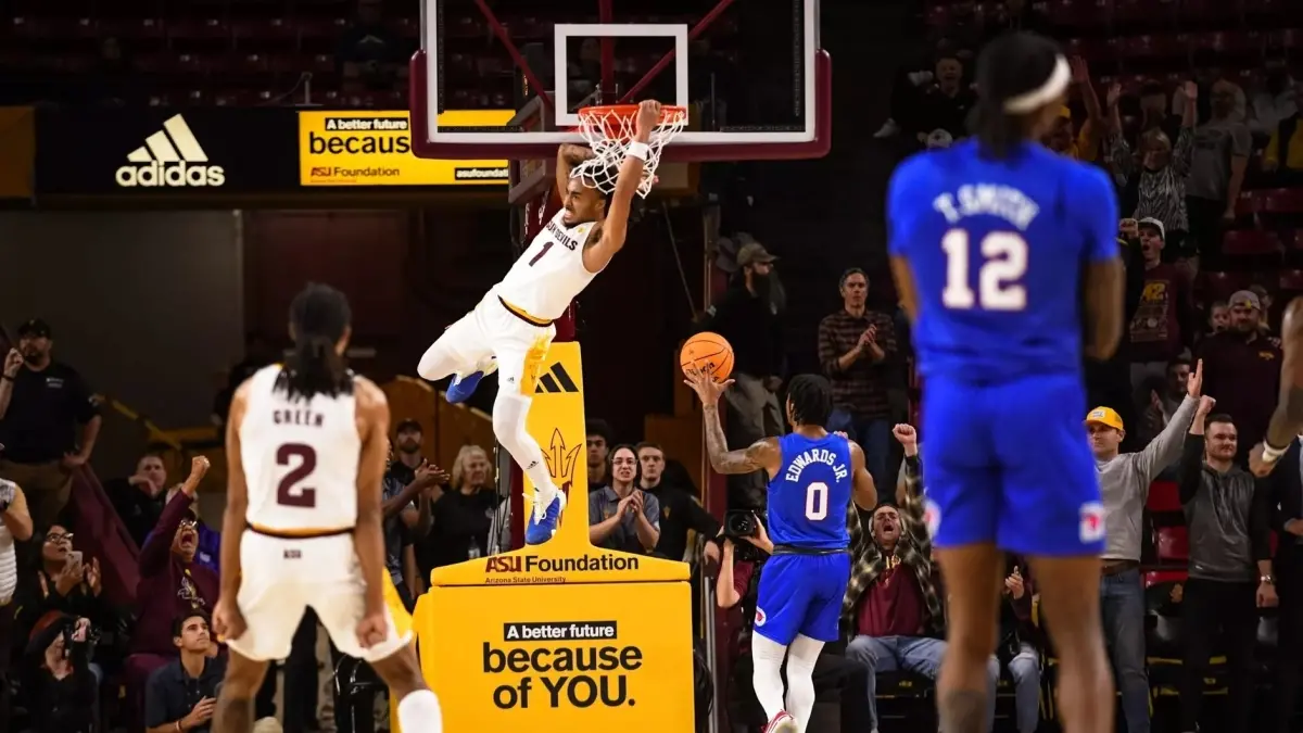male basketball player dunking basketball