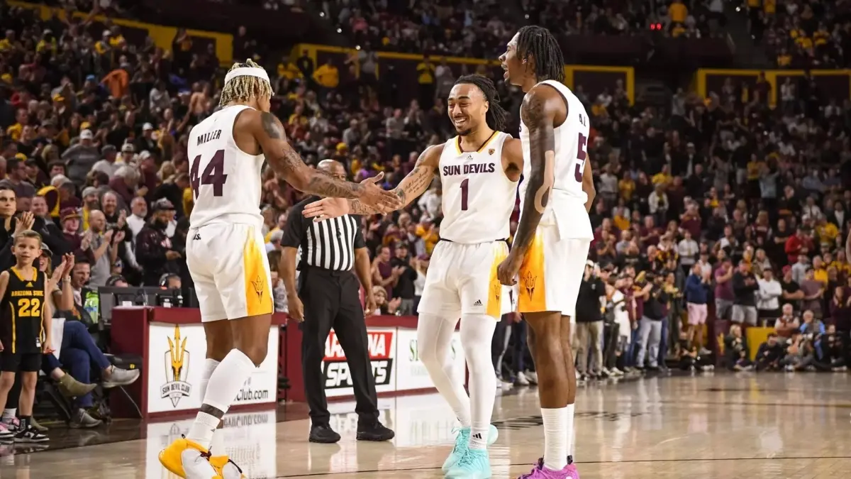 three basketball players celebrating on court three basketball players celebrating on court