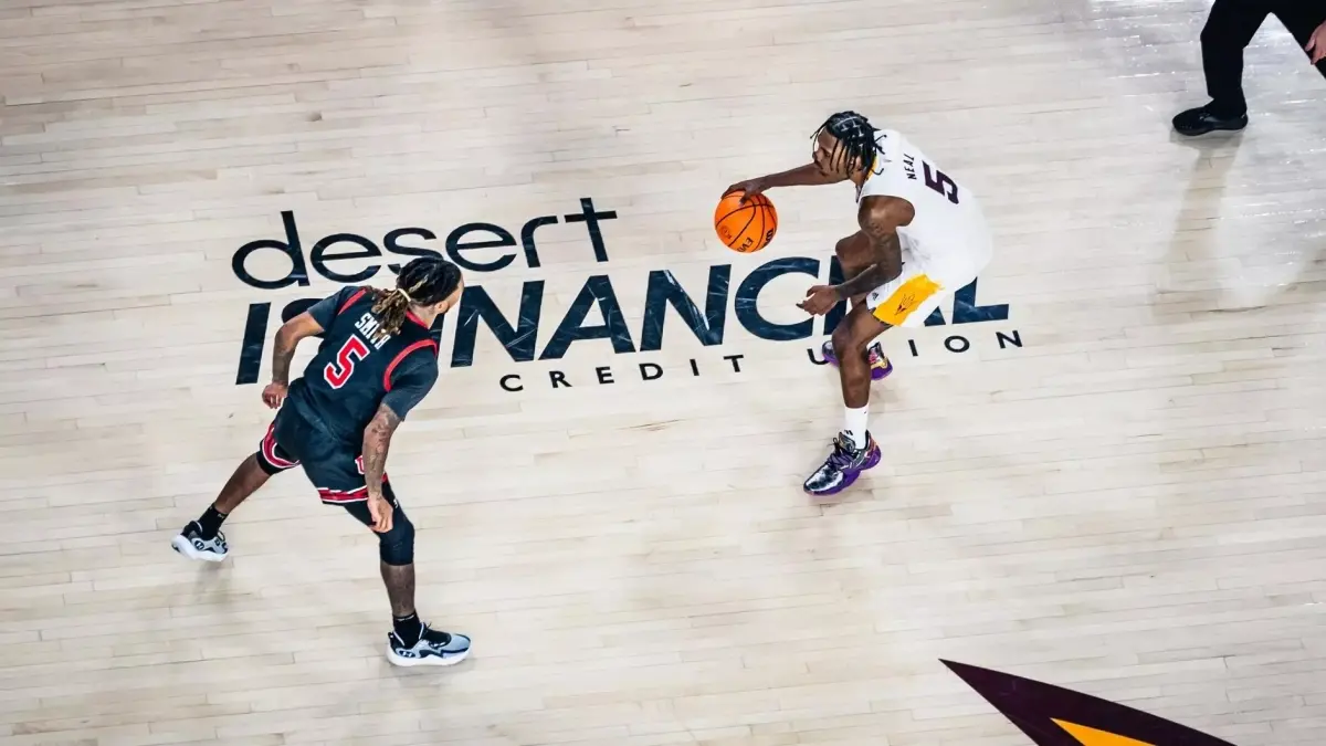 basketball player dribbling ball while opponent plays defense basketball player dribbling ball while opponent plays defense