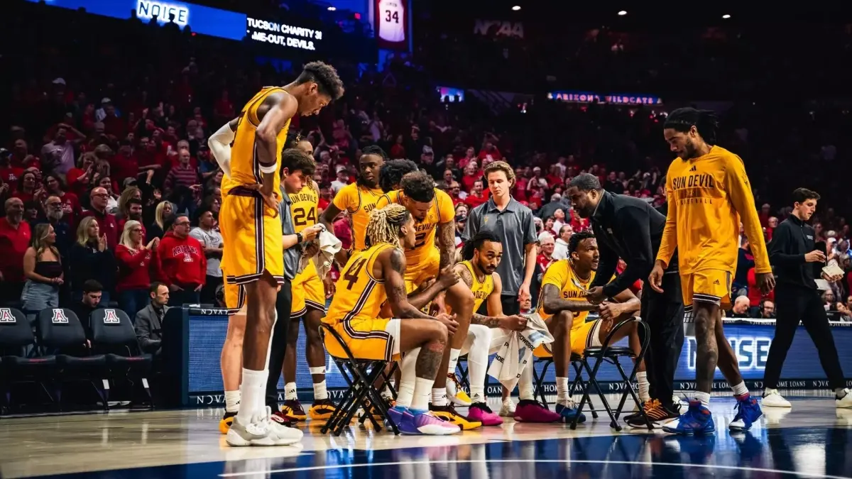 basketball team huddled around coach on court basketball team huddled around coach on court