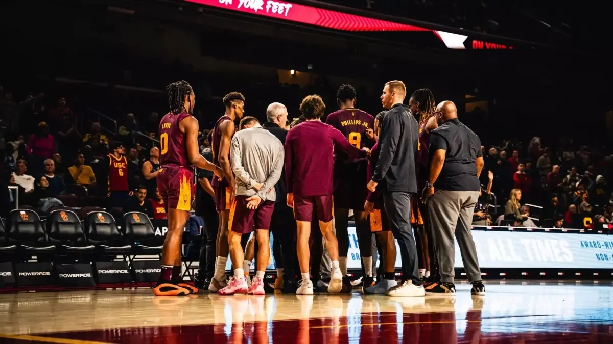 basketball team huddled around coach on court basketball team huddled around coach on court