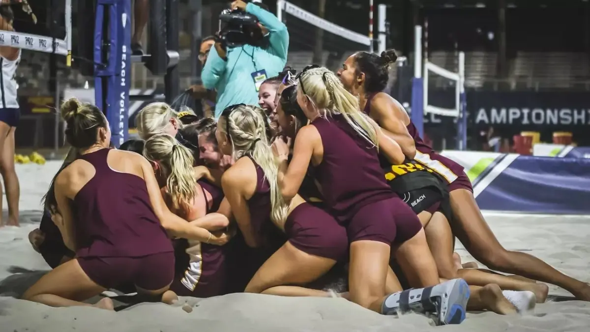 beach volleyball team sitting in sand laughing beach volleyball team sitting in sand laughing