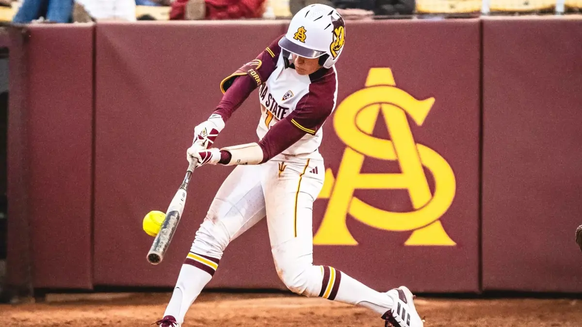 softball player swinging bat at ball softball player swinging bat at ball