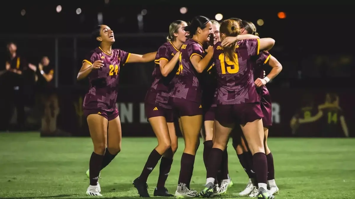 Photo by: Sun Devil Athletics<br />
six soccer players hugging on the field