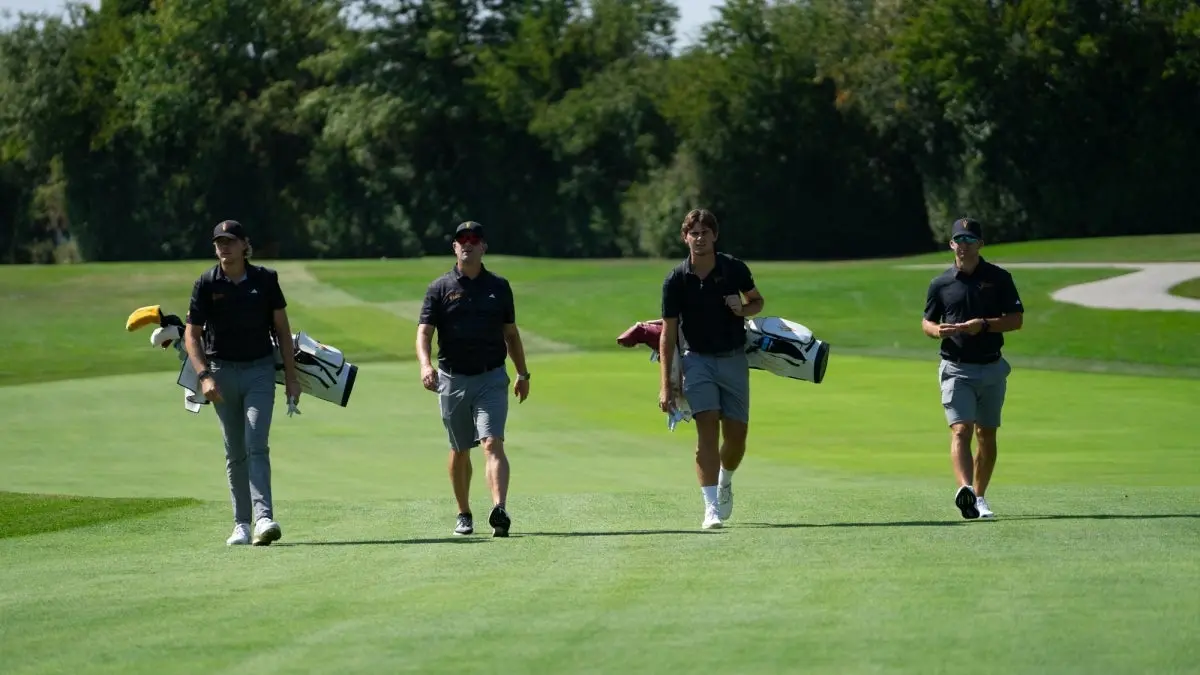 Coaches and Players walking in fairway